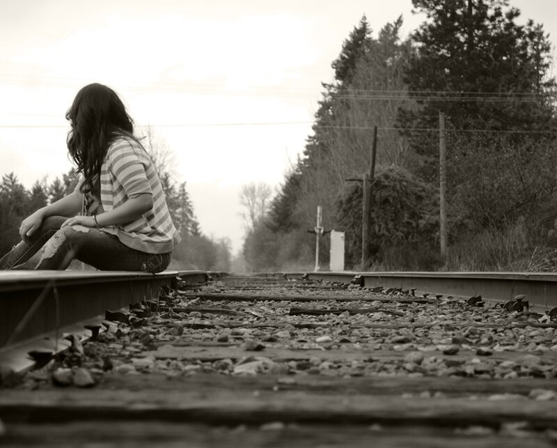 Woman Sitting on Train Tracks — Black, Melancholic, Photograph, Train Tracks