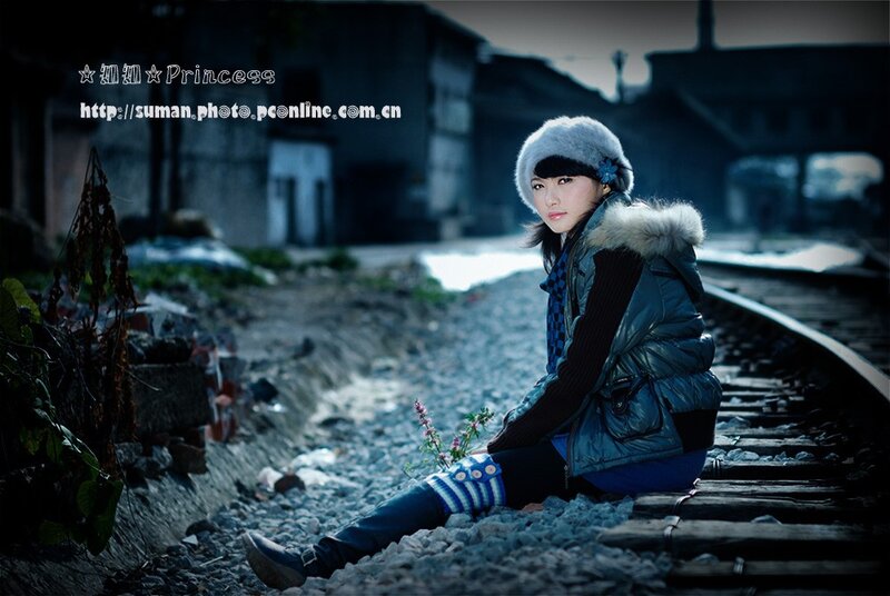 Woman Sitting on Train Tracks — Blue, Dramatic