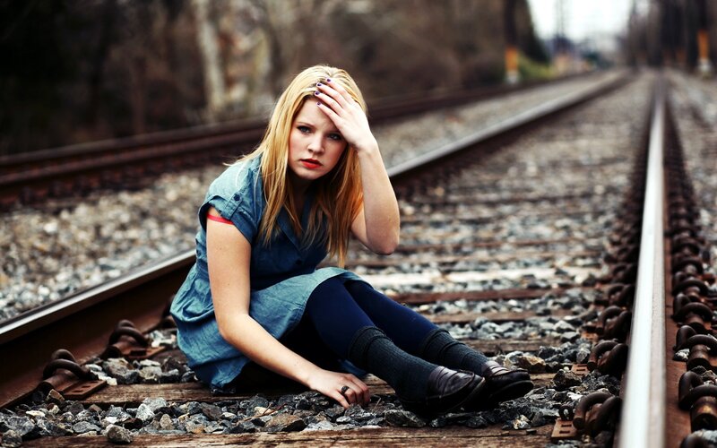 Woman Sitting on Train Tracks — Blue, Melancholic