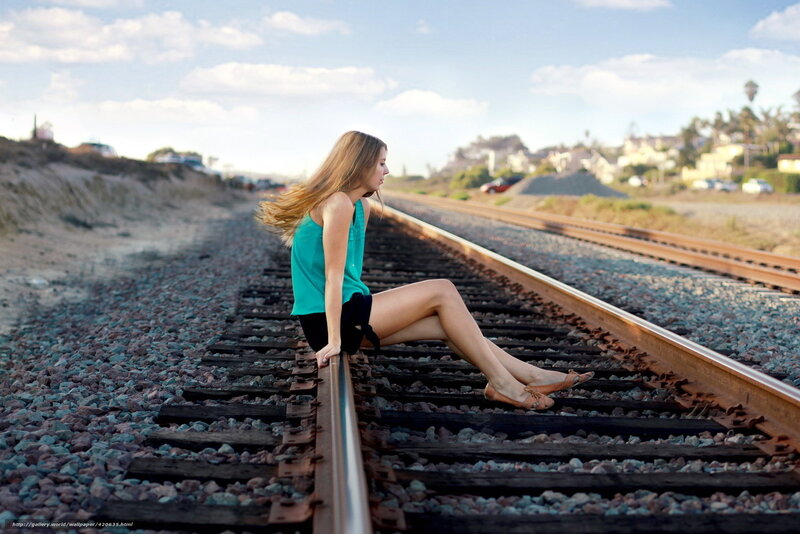 Woman Sitting on Train Tracks — Blue, Serene