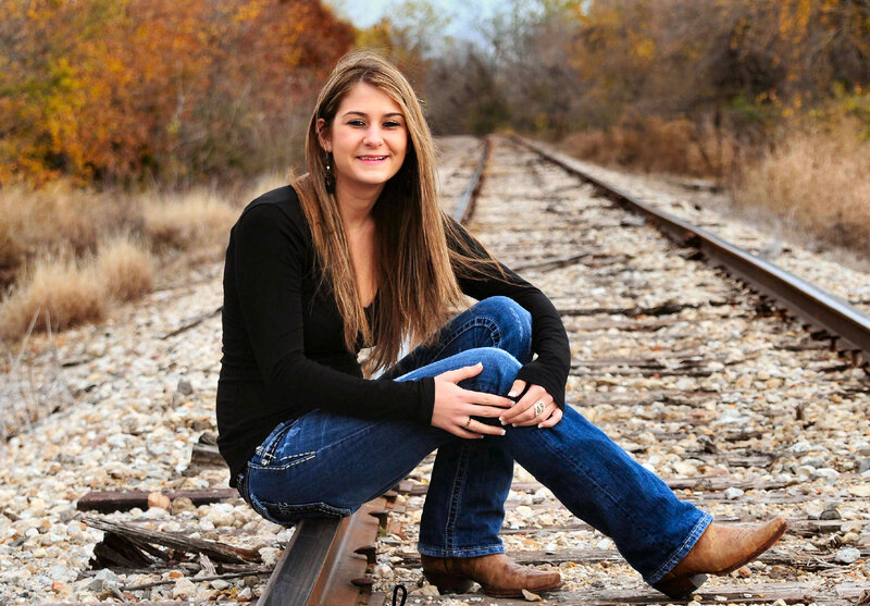 Woman Sitting on Train Tracks — Brown, Calm