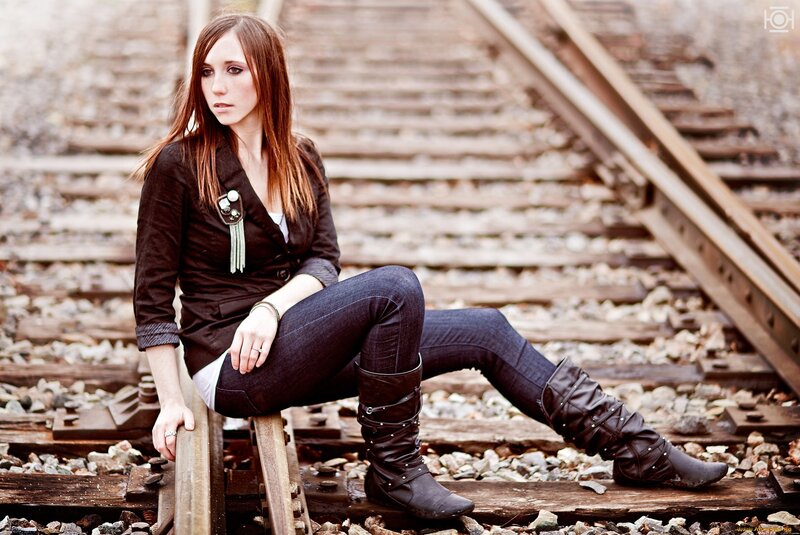Woman Sitting on Train Tracks — Brown, Contemplative