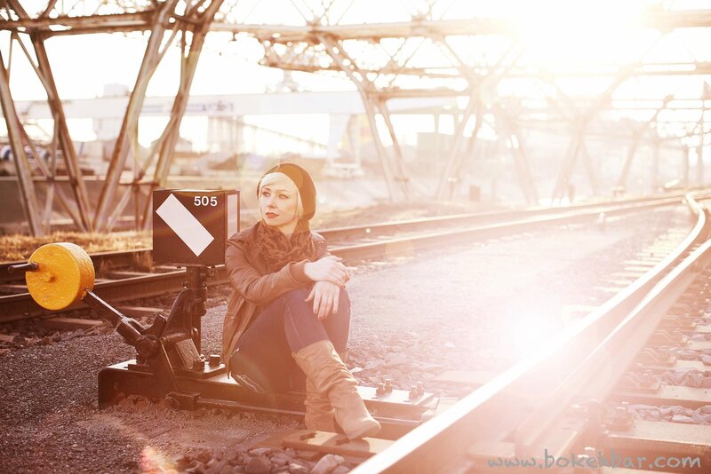 Woman Sitting on Train Tracks — Brown, Dramatic, Sunset