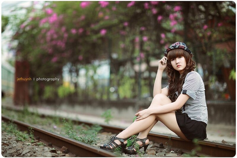 Woman Sitting on Train Tracks — Green, Calm