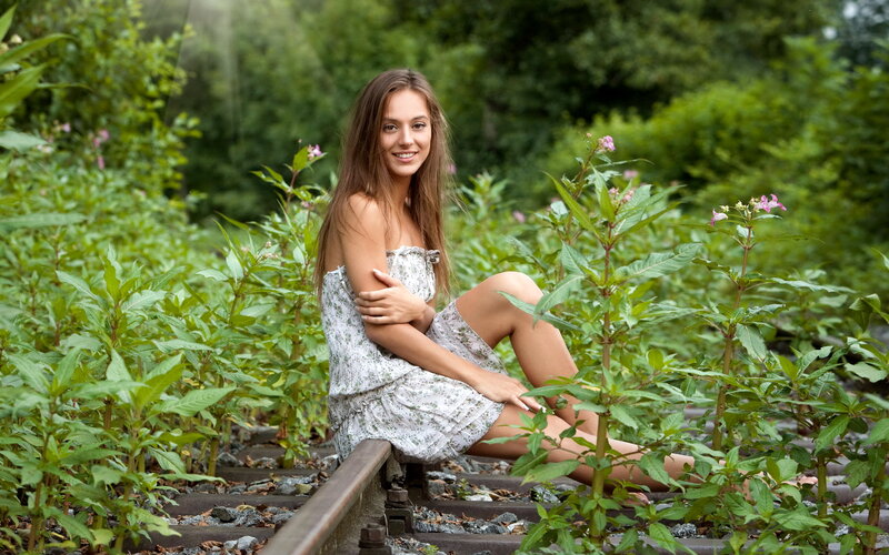 Woman Sitting on Train Tracks — Green