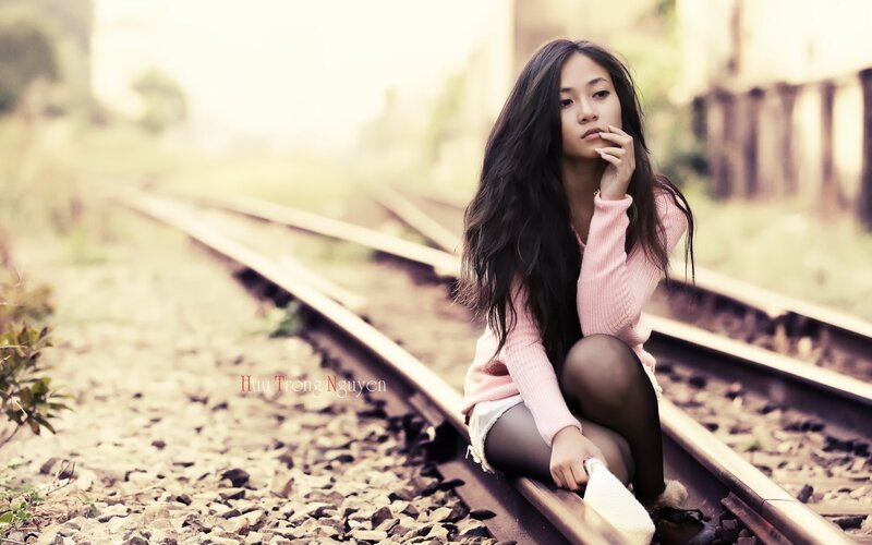 Woman Sitting on Train Tracks — Pink