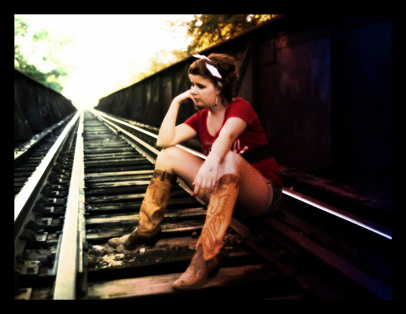Woman Sitting on Train Tracks — Red