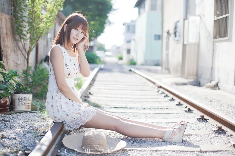 Woman Sitting on Train Tracks — White, Serene