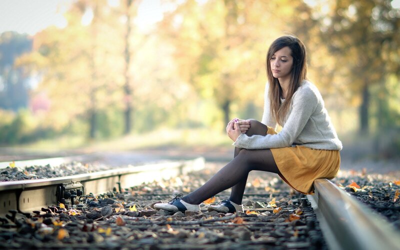 Woman Sitting on Train Tracks — Yellow, Melancholic, Autumn