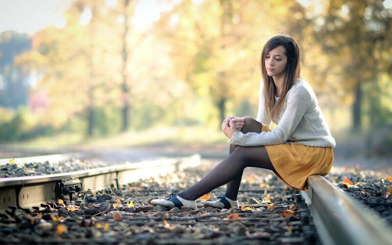 Woman Sitting on Train Tracks — Yellow