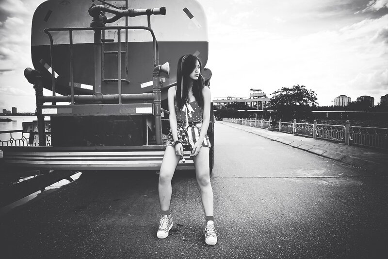Woman sitting on truck in black and white