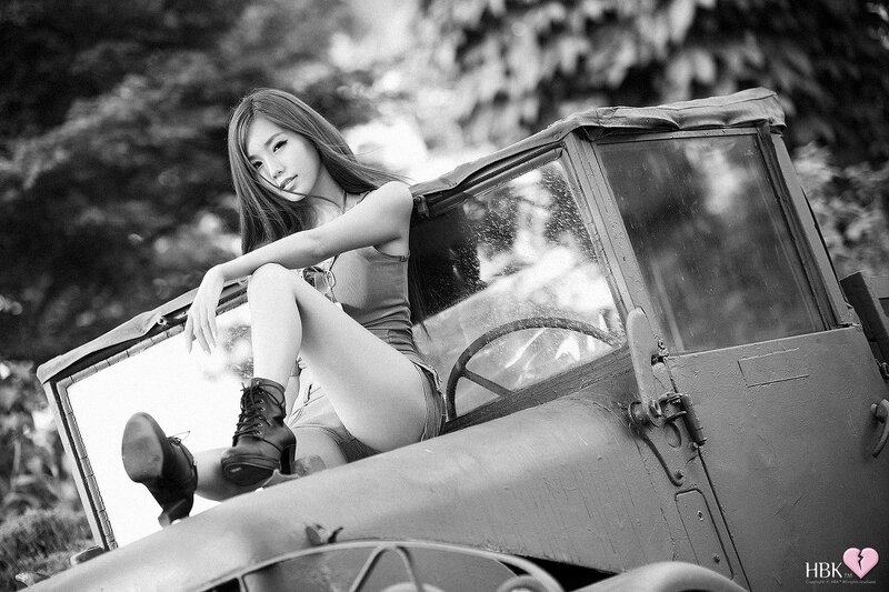 woman sitting on vintage car