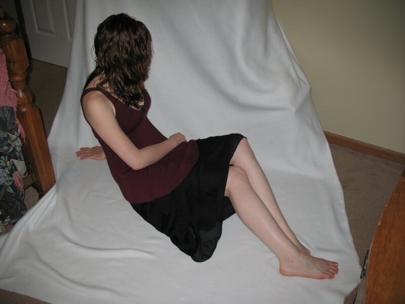 woman sitting on white sheet
