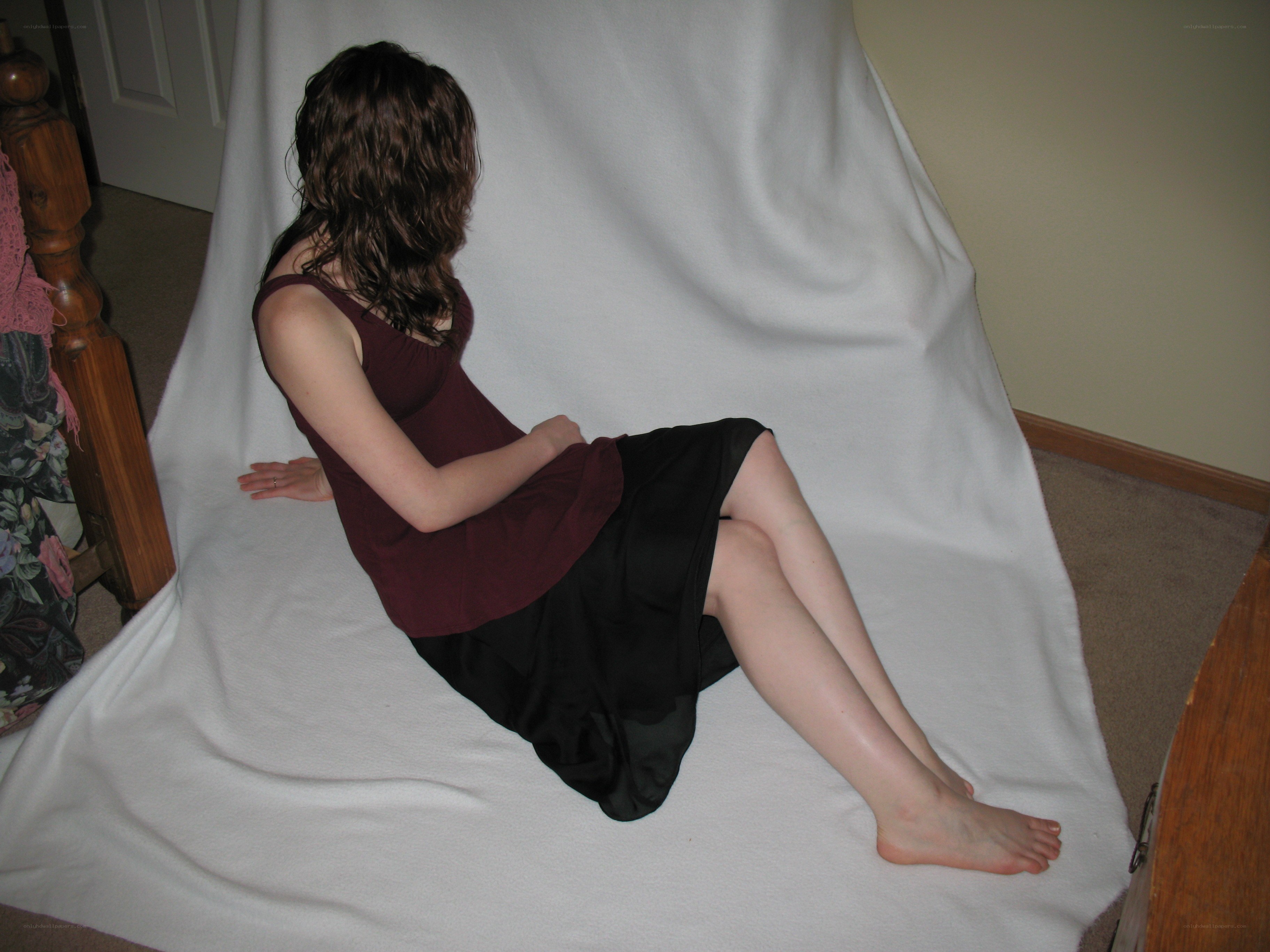 woman sitting on white sheet