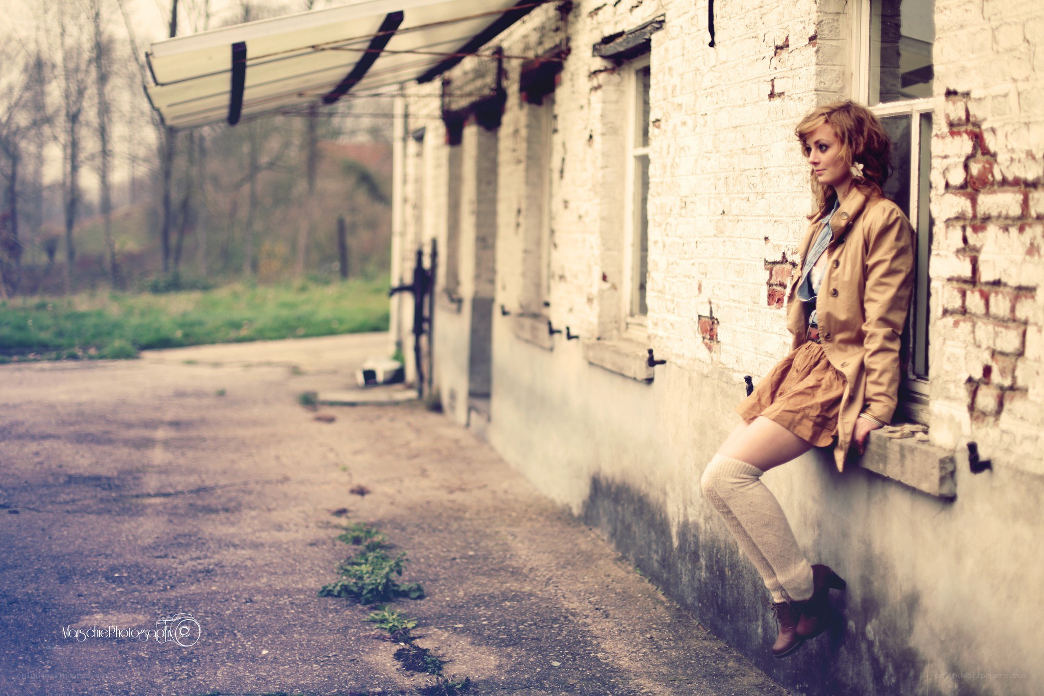 woman sitting on window ledge