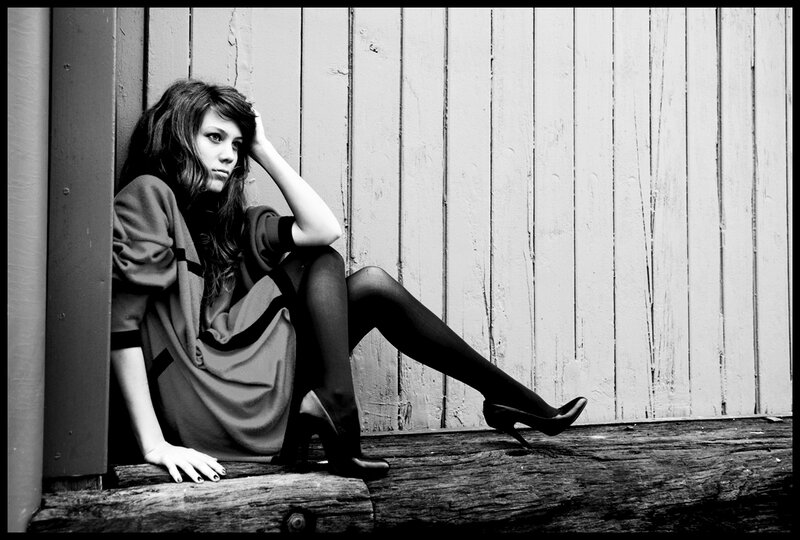 Woman Sitting on Wood — Black