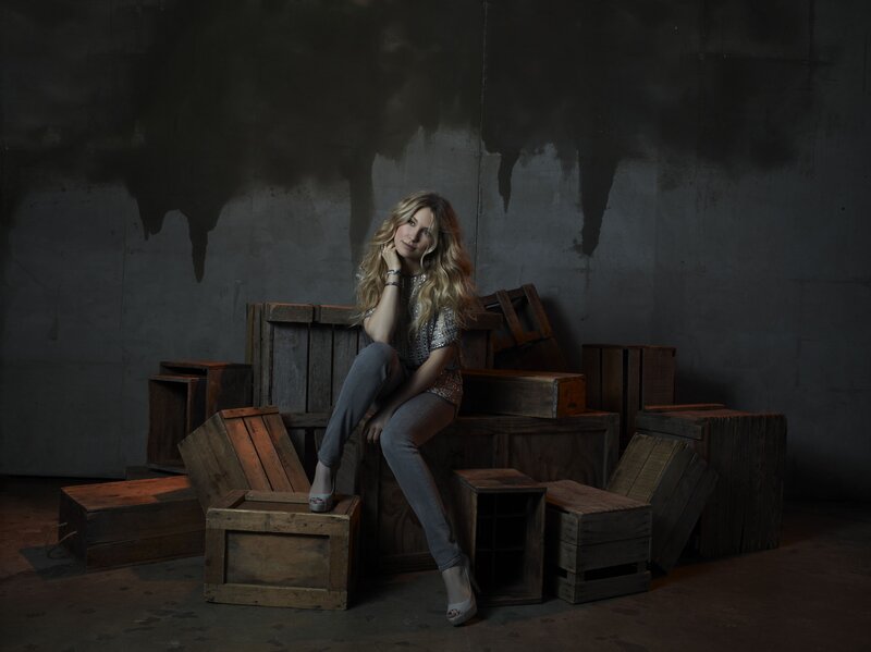 woman sitting on wooden crates
