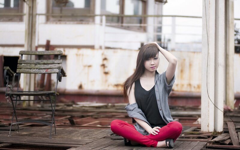 woman sitting on wooden deck
