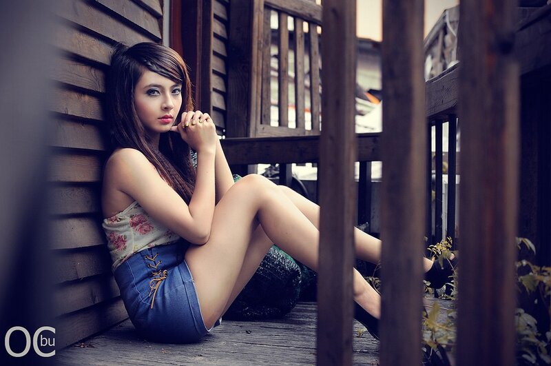 woman sitting on wooden deck