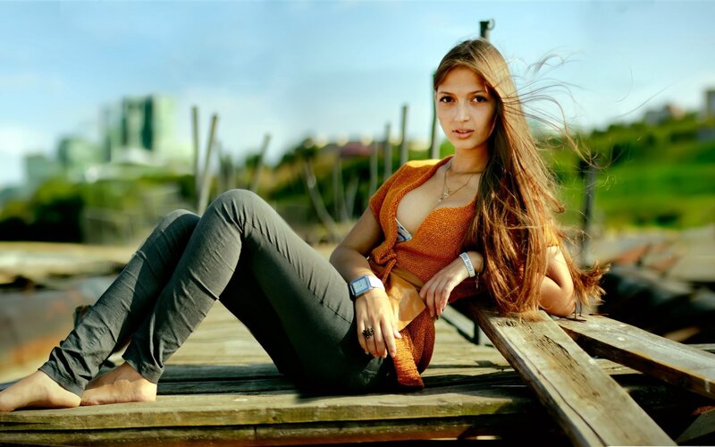 woman sitting on wooden dock