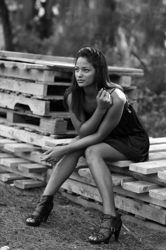 woman sitting on wooden pallets