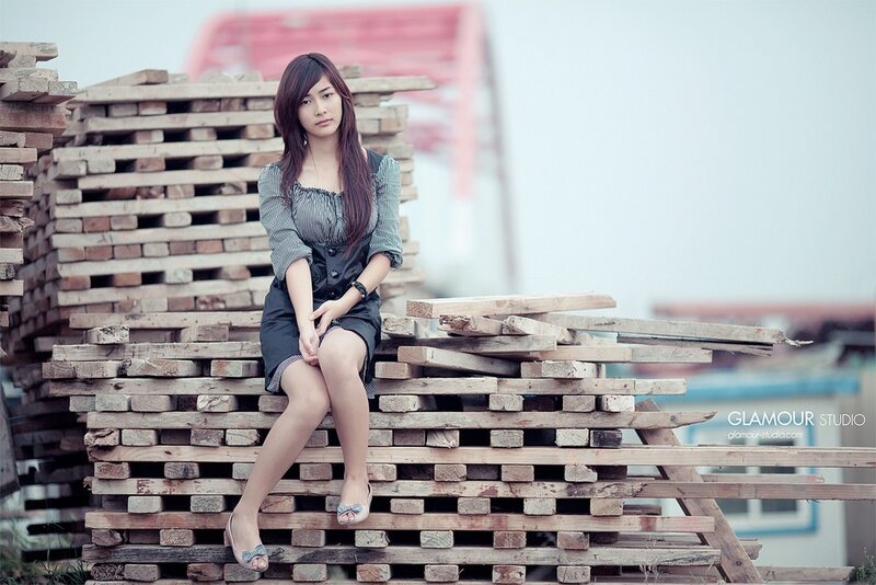 woman sitting on wooden pallets