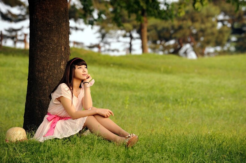 Woman sitting under a tree