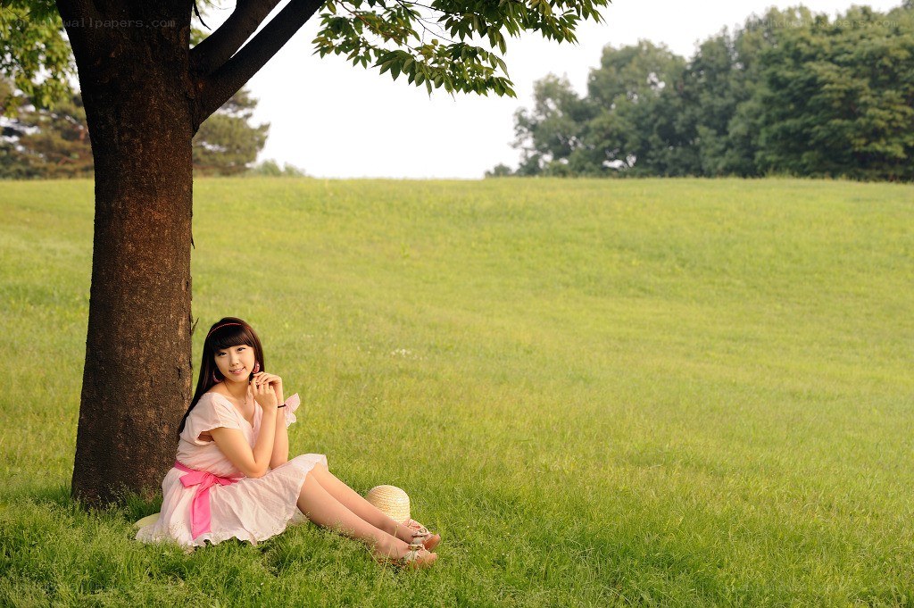 Woman sitting under a tree