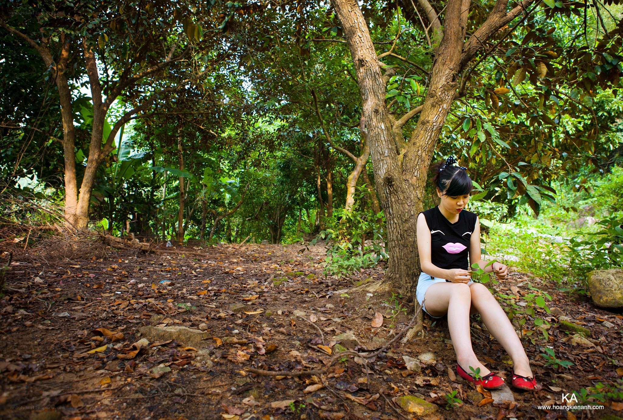 Woman sitting under a tree