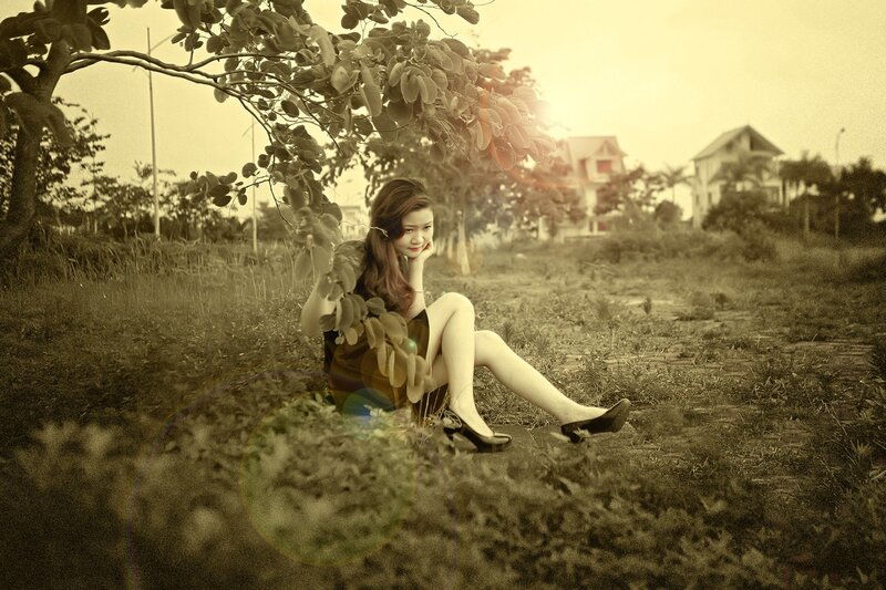 Woman sitting under a tree