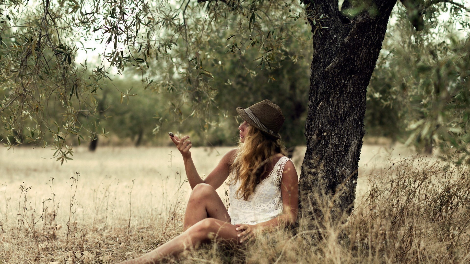 woman sitting under olive tree