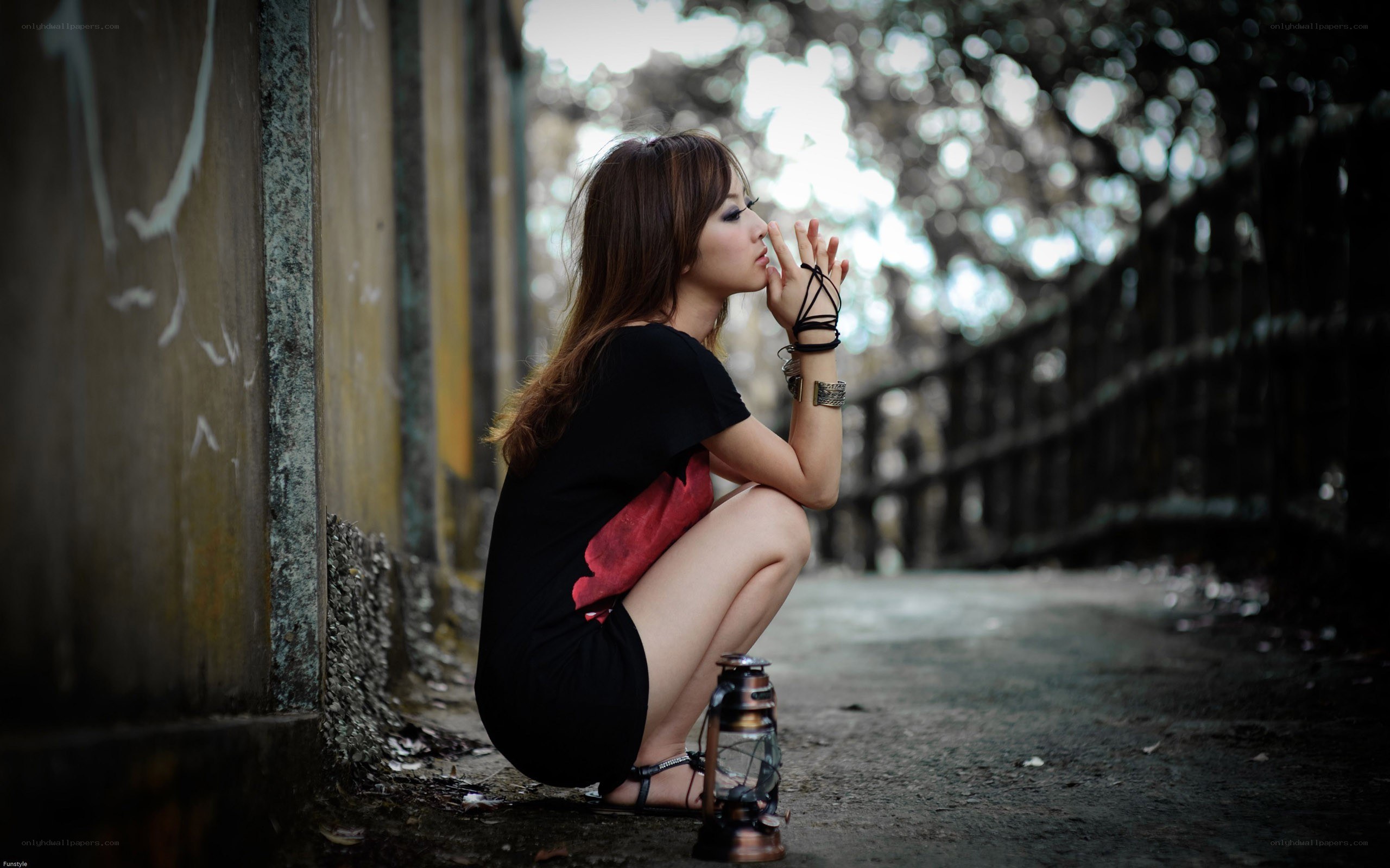 woman sitting with lantern