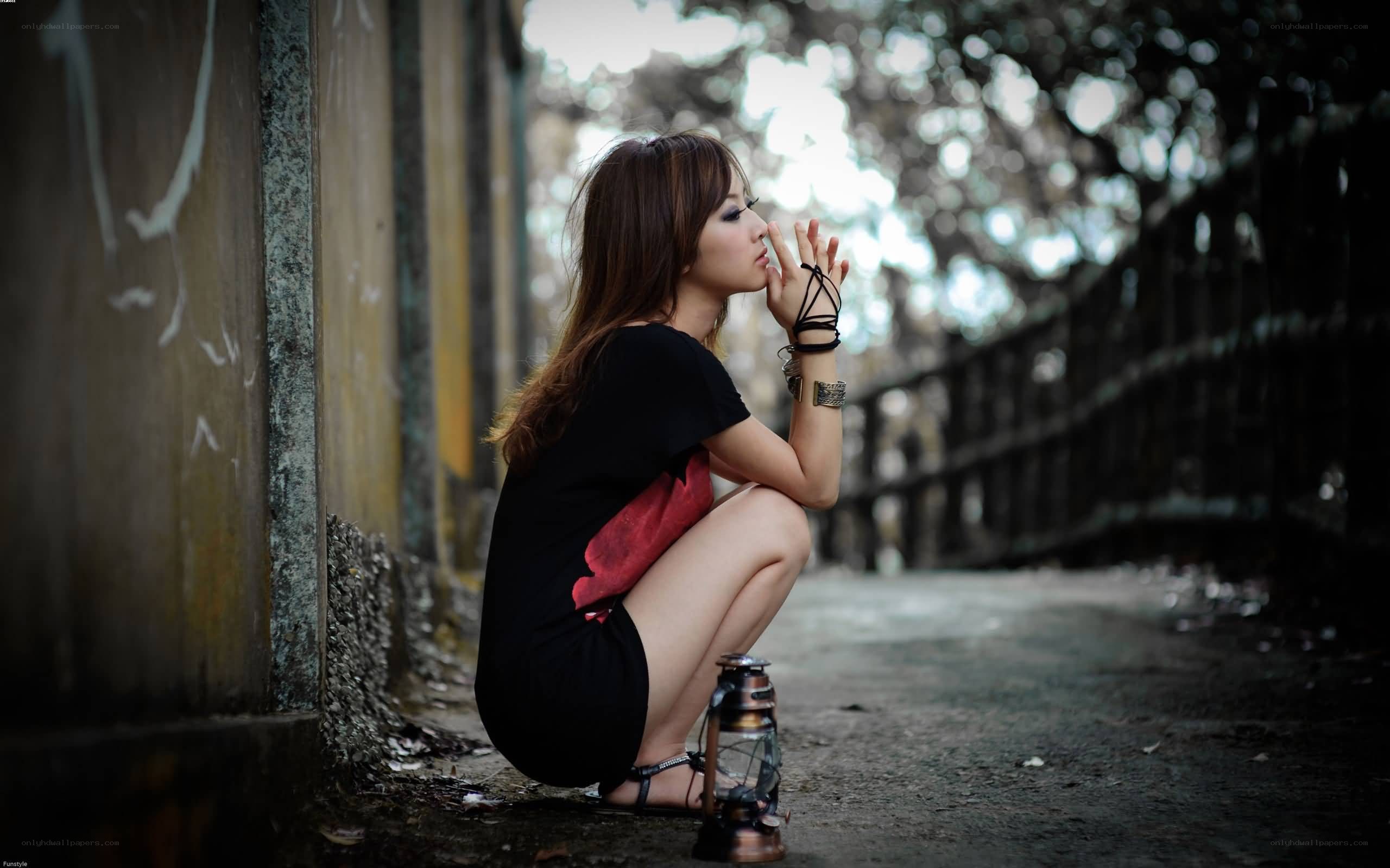 woman sitting with lantern