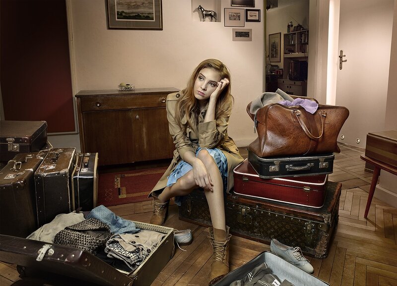woman sitting with luggage