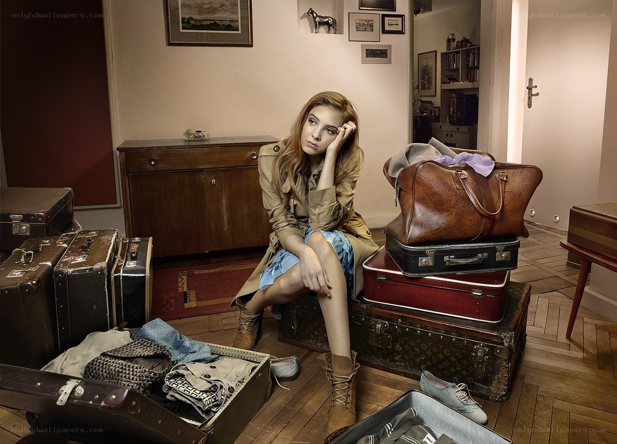 woman sitting with luggage