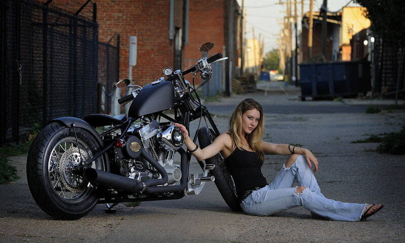 woman sitting with motorcycle