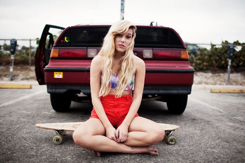 woman sitting with skateboard