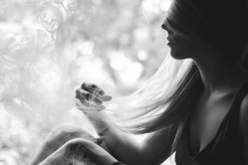 Woman Sitting with Smoke