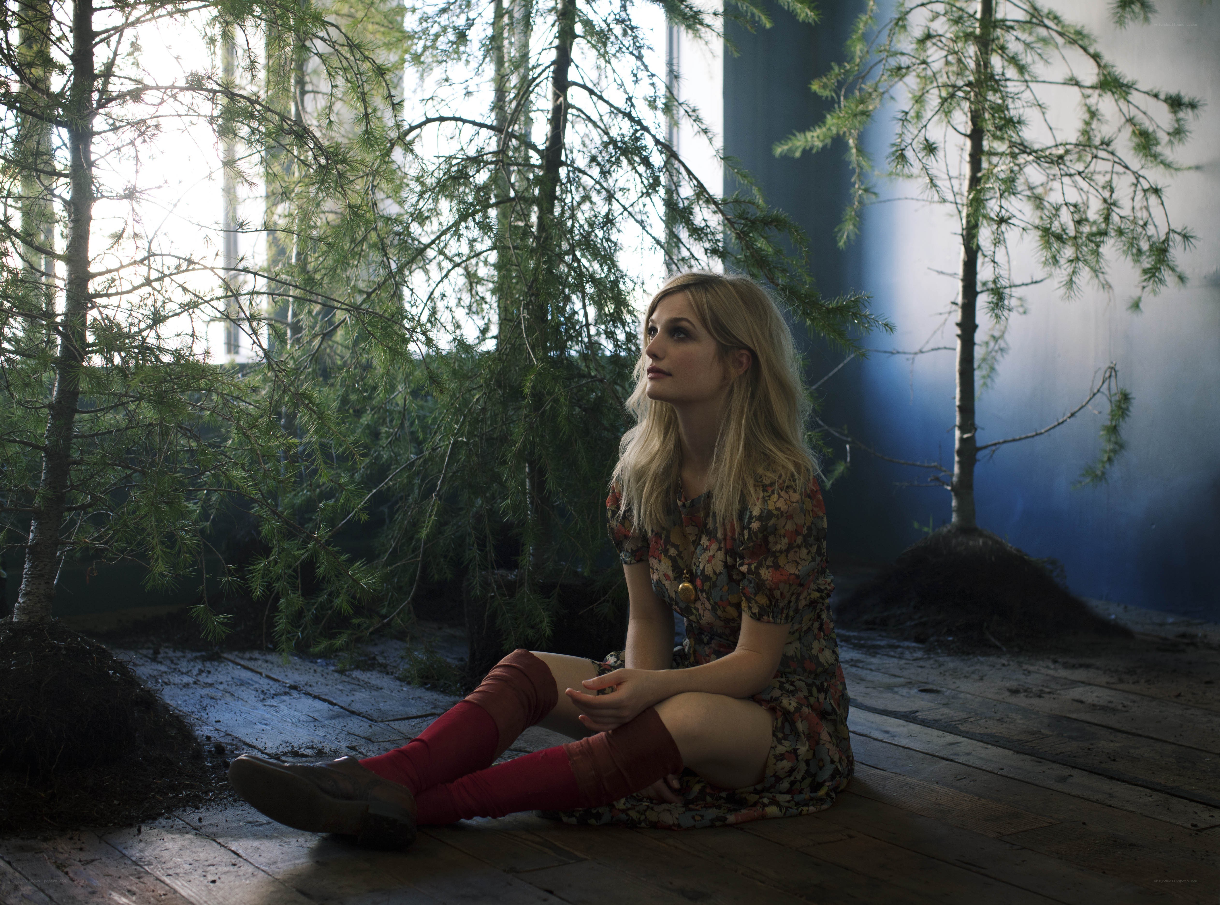 Woman sitting with trees