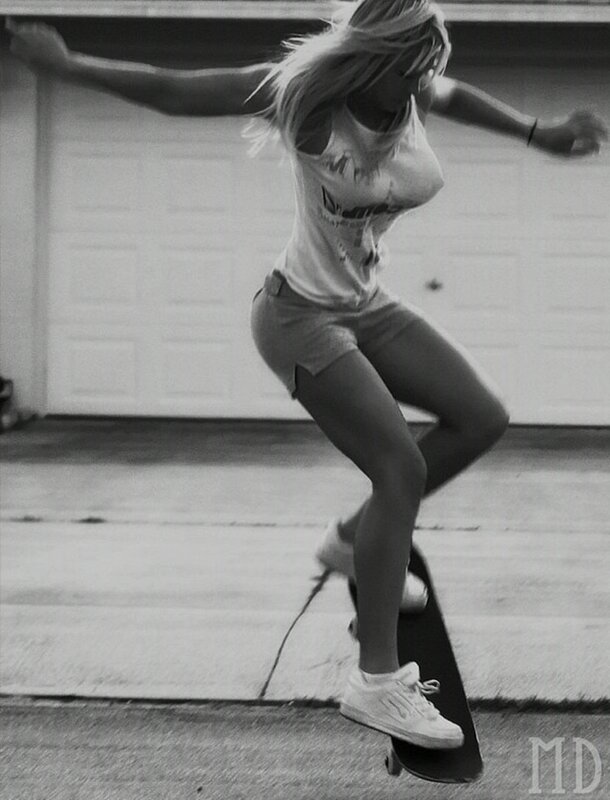 woman skateboarding in driveway