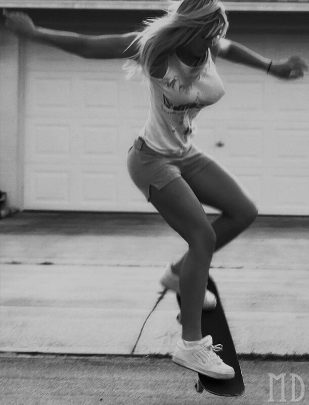 woman skateboarding in driveway