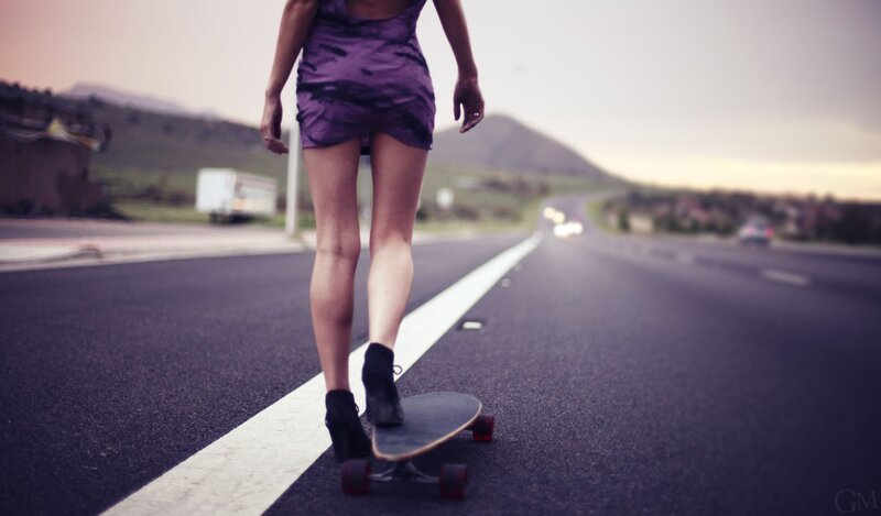 woman skateboarding on road