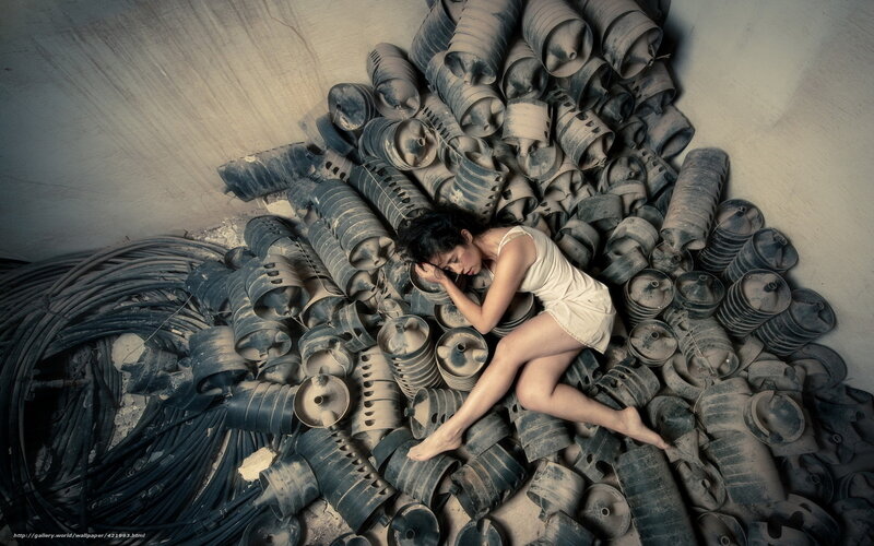 Woman sleeping among industrial parts
