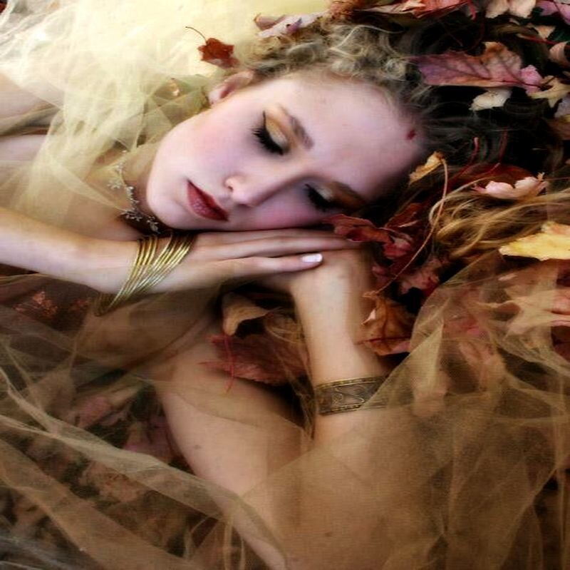 Woman Sleeping Among Leaves