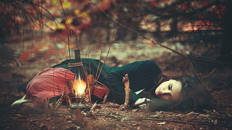 Woman sleeping in forest