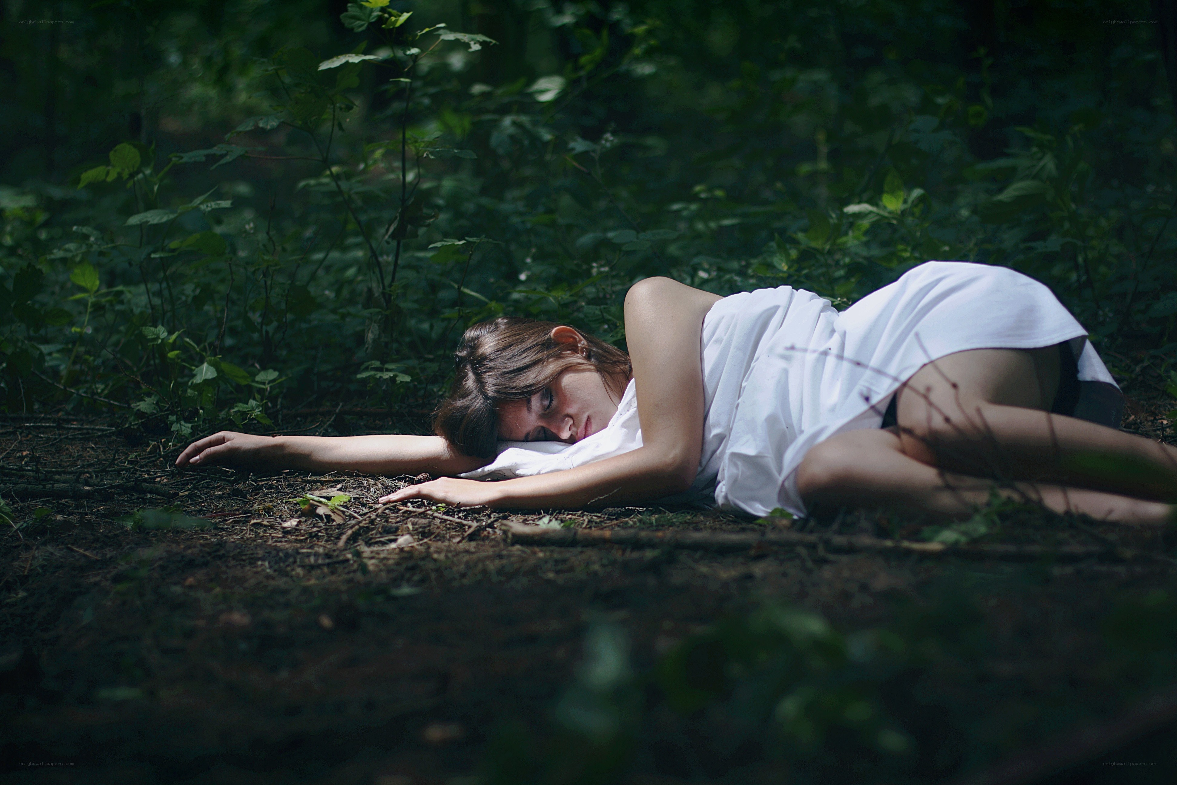 Woman sleeping in forest