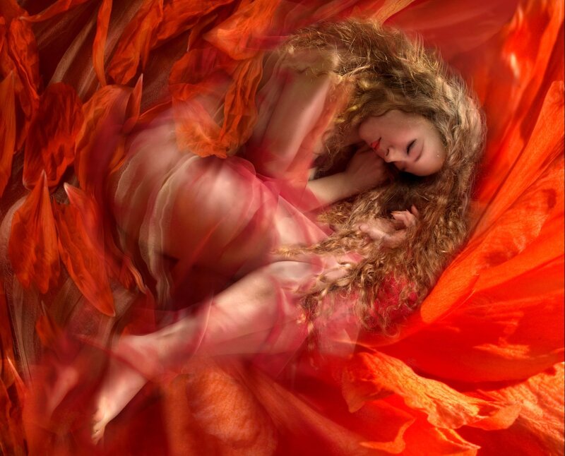 woman sleeping in red fabric