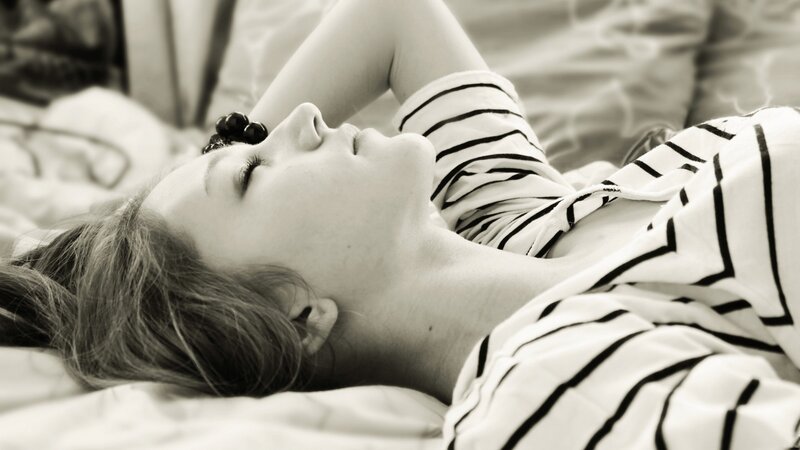 Woman Sleeping on Bed — Black, Serene, Photograph, Striped Shirt