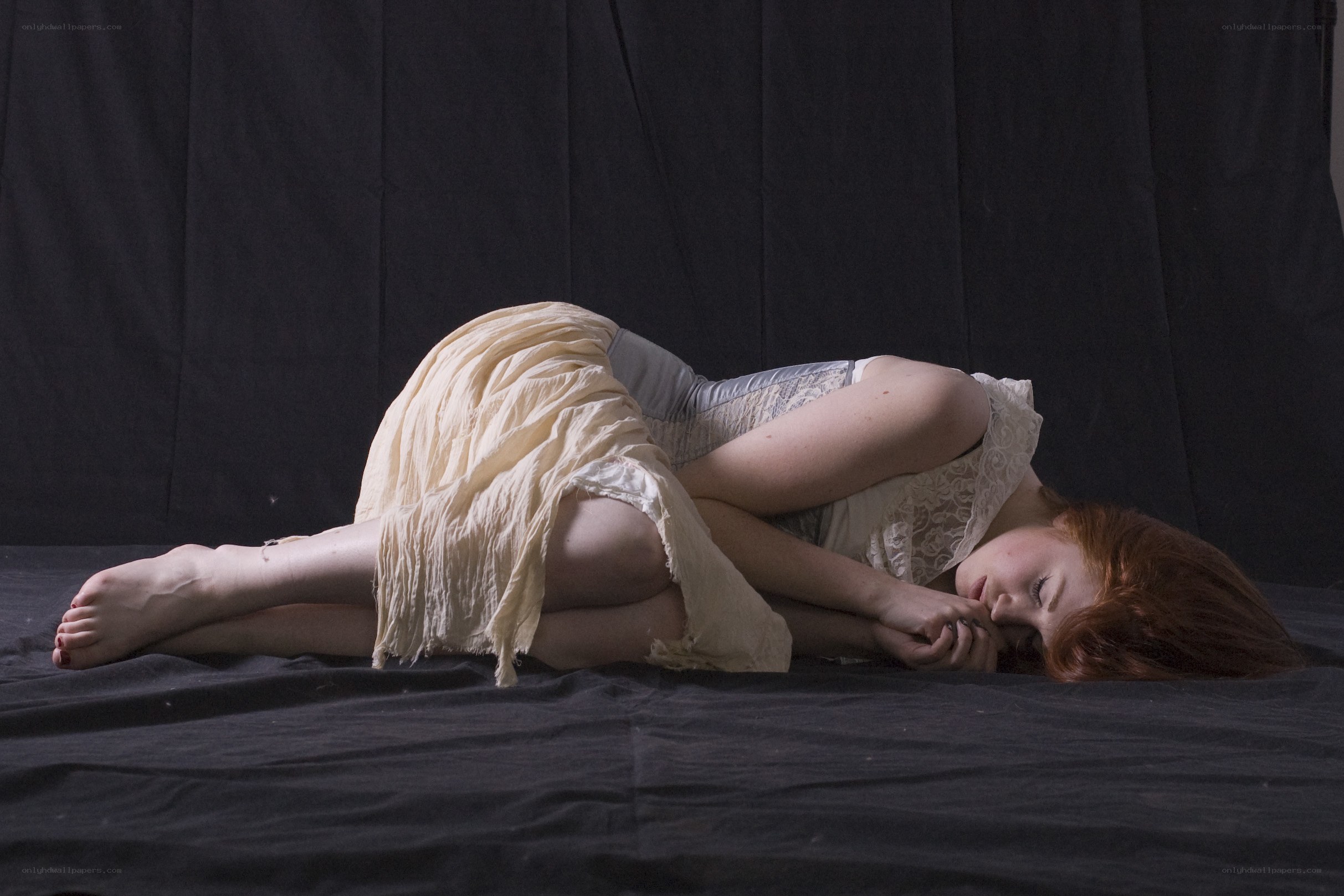 woman sleeping on dark surface
