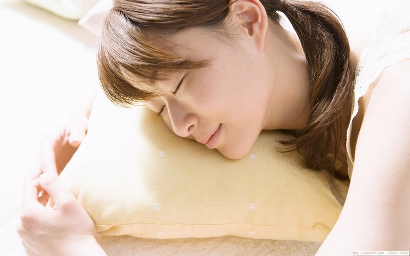 woman sleeping on pillow